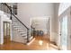 Elegant foyer with hardwood floors, a staircase, and a view into the dining room at 1035 Eagles Brooke Dr, Locust Grove, GA 30248