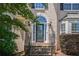 Close-up of the front door with decorative glass and stone steps, showing attention to detail at 1035 Eagles Brooke Dr, Locust Grove, GA 30248