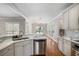 Open-concept kitchen with stainless steel appliances, marble countertops, tile backsplash, and hardwood flooring at 1035 Eagles Brooke Dr, Locust Grove, GA 30248