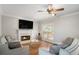 Cozy living room with a fireplace, hardwood floors, and comfortable seating, perfect for relaxation at 1035 Eagles Brooke Dr, Locust Grove, GA 30248
