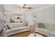 Bright living room featuring hardwood floors, neutral paint, and stylish sofas, creating an inviting space at 1035 Eagles Brooke Dr, Locust Grove, GA 30248