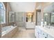 Bright main bathroom boasts double sinks, a soaking tub and a glass enclosed shower at 1035 Eagles Brooke Dr, Locust Grove, GA 30248