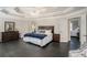 Large main bedroom with tray ceiling and access to the ensuite bath and dressing area at 1035 Eagles Brooke Dr, Locust Grove, GA 30248