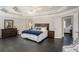 Large main bedroom showcases a tray ceiling, dark floors, and access to an adjoining room at 1035 Eagles Brooke Dr, Locust Grove, GA 30248