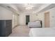 Large main bedroom with tray ceiling, ceiling fan, and access to the outdoors through glass paneled doors at 1035 Eagles Brooke Dr, Locust Grove, GA 30248