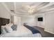 Comfortable main bedroom with tray ceiling, dark wood floors, TV, and bright windows at 1035 Eagles Brooke Dr, Locust Grove, GA 30248