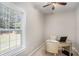 Home office with natural light, neutral colors, ceiling fan and a round desk at 1035 Eagles Brooke Dr, Locust Grove, GA 30248