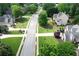 A wide shot of the street showcasing houses, trees, and well-manicured lawns in a serene neighborhood at 1035 Eagles Brooke Dr, Locust Grove, GA 30248