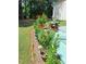 Landscaped backyard with beautiful flowers and a cozy patio area at 3102 Aberdeen Cv, Lithonia, GA 30038