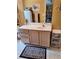 Bathroom featuring a vanity with ample storage space and an ornate mirror above at 3102 Aberdeen Cv, Lithonia, GA 30038