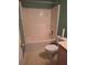 Bathroom featuring a shower and toilet with laminate floors and green walls at 3102 Aberdeen Cv, Lithonia, GA 30038