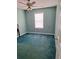 Bedroom with a ceiling fan, window, and teal carpet at 3102 Aberdeen Cv, Lithonia, GA 30038