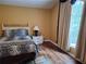 Bedroom featuring wood floors, a leopard print bed set, large window, and neutral walls at 3102 Aberdeen Cv, Lithonia, GA 30038