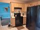 Charming kitchen featuring light wood cabinets and black appliances at 3102 Aberdeen Cv, Lithonia, GA 30038