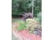 Well-maintained garden featuring manicured bushes, vibrant ground cover, and lush foliage at 3102 Aberdeen Cv, Lithonia, GA 30038