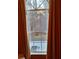 Window view displaying a yard and wooded area through a large window with tan curtains at 3102 Aberdeen Cv, Lithonia, GA 30038