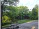 Spacious backyard featuring a stone table and bench seating, ideal for outdoor entertaining at 345 Oak Springs Nw Dr, Lawrenceville, GA 30043