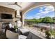Relaxing covered balcony with a fireplace, grill, comfortable seating, and a scenic view at 50 Canton St # 406, Alpharetta, GA 30009