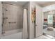 Well-lit bathroom features a shower/tub combo with stylish tile, and a doorway to the bedroom at 50 Canton St # 406, Alpharetta, GA 30009