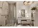 Elegant bathroom boasts a glass shower, vanity with plush seating, and decorative lighting at 50 Canton St # 406, Alpharetta, GA 30009