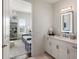 Bright bathroom with white vanity next to bedroom with a crystal chandelier at 50 Canton St # 406, Alpharetta, GA 30009