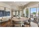 Bright dining room with beautiful hardwood floors, modern lighting, and sliding glass doors to outdoor balcony at 50 Canton St # 406, Alpharetta, GA 30009