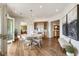 Open dining room with a wet bar, chandelier, and hardwood floors at 50 Canton St # 406, Alpharetta, GA 30009