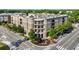 Stunning exterior view of a well-maintained condominium building with tree-lined sidewalks at 50 Canton St # 406, Alpharetta, GA 30009