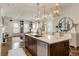 Bright, open kitchen boasts a large island, granite countertops, and decorative pendant lighting overlooking the living area at 50 Canton St # 406, Alpharetta, GA 30009