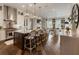 Open-concept kitchen, featuring a large island with seating and stainless steel appliances at 50 Canton St # 406, Alpharetta, GA 30009