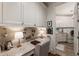 Bright laundry room features desk, front load washer and dryer, granite countertops and ample cabinet space at 50 Canton St # 406, Alpharetta, GA 30009