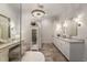 Elegant bathroom featuring dual vanities, chandelier lighting, and a separate makeup vanity area at 50 Canton St # 406, Alpharetta, GA 30009