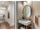 Stylish powder room with marble sink, brass accents, patterned wallpaper, near the laundry room at 50 Canton St # 406, Alpharetta, GA 30009