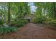 Landscaped backyard with a stream and view of the multi-level home exterior at 842 Laurel Crest Sw Ct, Marietta, GA 30064
