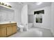 Bright bathroom with tub, wood vanity, and window at 842 Laurel Crest Sw Ct, Marietta, GA 30064