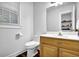 Half bath with wood floors and white commode at 842 Laurel Crest Sw Ct, Marietta, GA 30064
