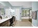 Primary bathroom showcasing a soaking tub, tile floors, and a long vanity at 842 Laurel Crest Sw Ct, Marietta, GA 30064