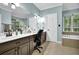 Primary bathroom featuring a soaking tub, tile floors, and a long vanity at 842 Laurel Crest Sw Ct, Marietta, GA 30064