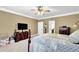 Main bedroom with neutral carpet, ceiling fan and a dark wood dresser at 842 Laurel Crest Sw Ct, Marietta, GA 30064