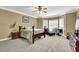 Spacious bedroom with neutral carpet, a ceiling fan, and a seating area at 842 Laurel Crest Sw Ct, Marietta, GA 30064