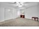 Bright bedroom features neutral carpet, white walls and trim, ceiling fan, and closet at 842 Laurel Crest Sw Ct, Marietta, GA 30064