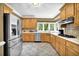 Bright kitchen features stainless steel appliances and wood cabinetry at 842 Laurel Crest Sw Ct, Marietta, GA 30064