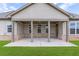 Covered back porch with brick accents and concrete flooring perfect for outdoor relaxation at 112 Leveret Rd, Locust Grove, GA 30248