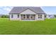 Spacious backyard with a covered patio perfect for entertaining, surrounded by lush green grass at 112 Leveret Rd, Locust Grove, GA 30248