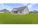 Backyard view featuring a covered patio and a large lawn, perfect for outdoor enjoyment at 112 Leveret Rd, Locust Grove, GA 30248