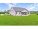 Home exterior showcasing a covered patio and expansive backyard perfect for outdoor activities at 112 Leveret Rd, Locust Grove, GA 30248