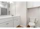 This bathroom features a large mirror, white cabinets and a toilet at 112 Leveret Rd, Locust Grove, GA 30248