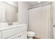 Bright bathroom featuring a modern vanity and a shower with a white curtain at 112 Leveret Rd, Locust Grove, GA 30248