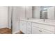 This bathroom has white cabinets, double sinks and a mirror at 112 Leveret Rd, Locust Grove, GA 30248