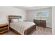 Cozy bedroom featuring neutral carpet, a full sized bed, and a wooden dresser at 112 Leveret Rd, Locust Grove, GA 30248